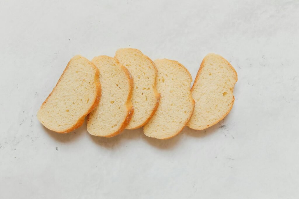 Sliced white bread arranged neatly for a rustic food presentation.